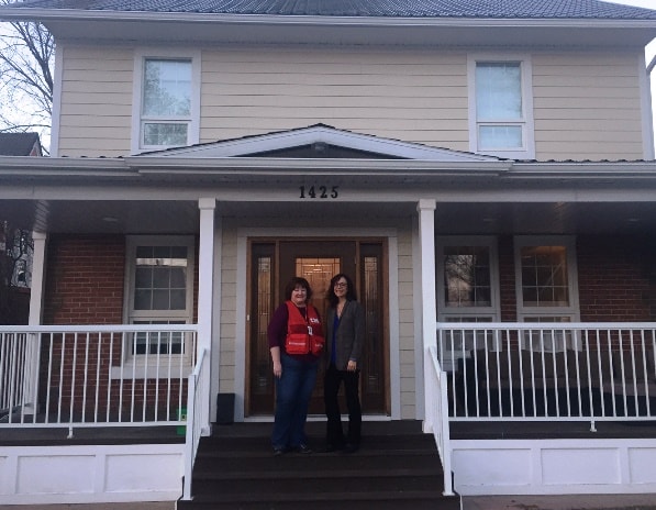 Pam and Barb outside the renovated house