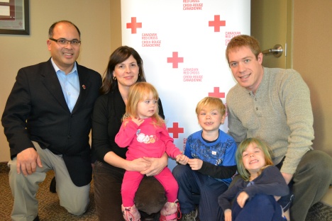 Owen (centre) along with his brother (Isaac), sister (Alexis) and parents (Sarah and Mark Williams) and the provincial director of the Red Cross in Nova Scotia, Ismael Aquino.