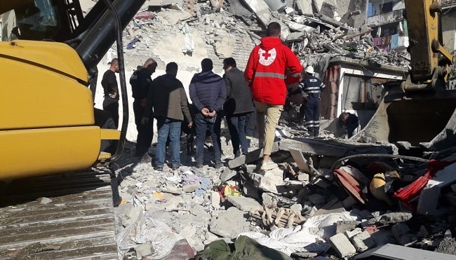 Red Cross Emergency workers look onto the damage of the Albania Earthquake