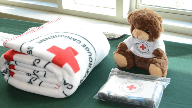 a teddy bear, a blanket, and hygiene kit from the CRC in response to the wildfires in Nova Scotia
