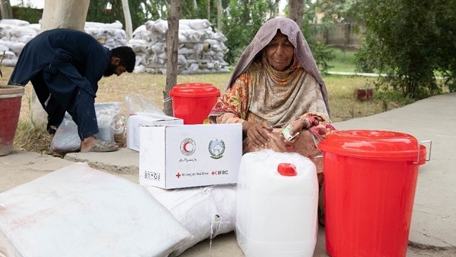Woman receiving Red Cross supplies