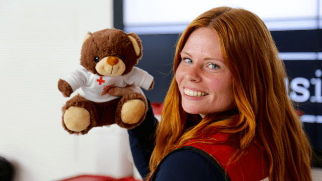 Rachel holding a teddy bear at Fort McMurray International Airport.