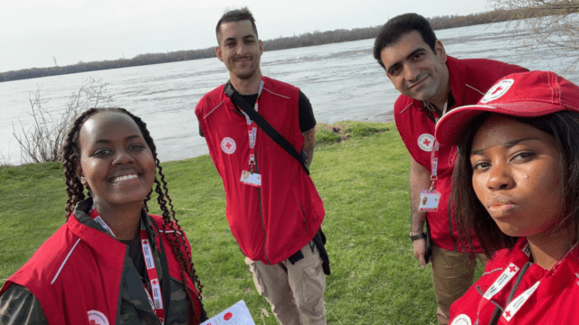 A group of four face-to-face fundraising Red Cross volunteers at a lake