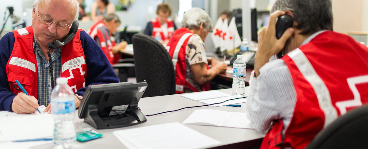 A group of Red Cross staff answer phones.