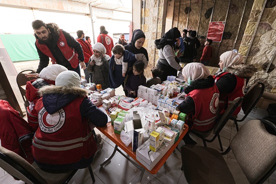 Red Crescent volunteers handing out supplies