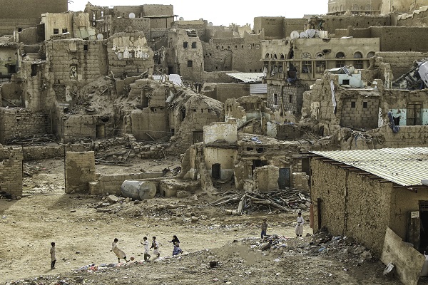 group of children playing in a war torn area