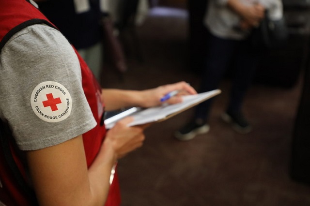 Close-up of Red Cross volunteer with a clip board