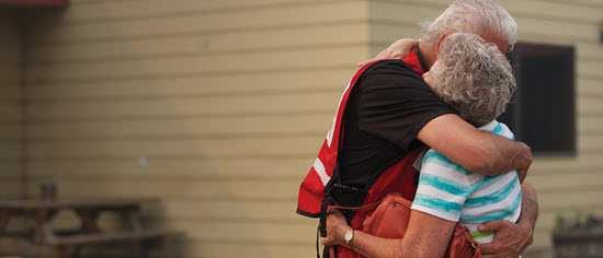 Three images of Red Cross volunteer hugging other people