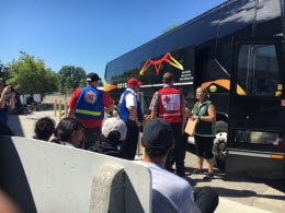 Volunteers prepare bus for evacuees to return home