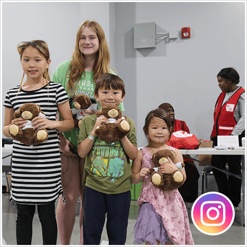 Four kids holding teddy bears at a shelter in Alberta during the wildfires in 2023