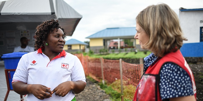 TTwo Canadian Red Cross delegates engage in conversation outside 