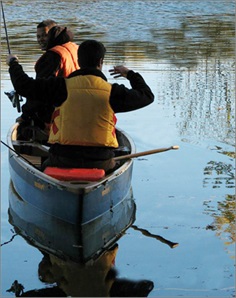 two men in a canoe fishing