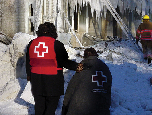Two Red Cross volunteers survey the damage of extreme cold weather.