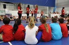 Kids watching a demonstration in a gym