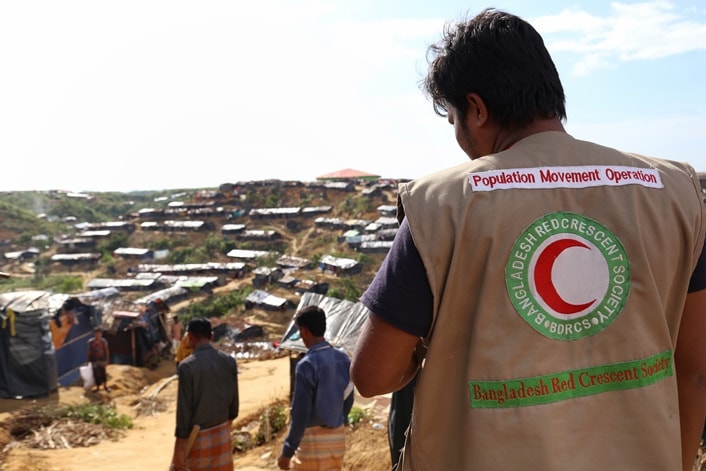 Bangladesh Red Crescent volunteeres look across Hakimpara Camp.
