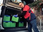 Man loading car with food