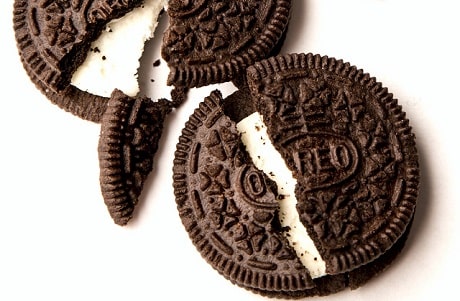 Two broken Oreo cookies with white background