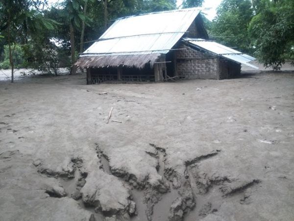 Homes covered in mud and sand after water recedes
