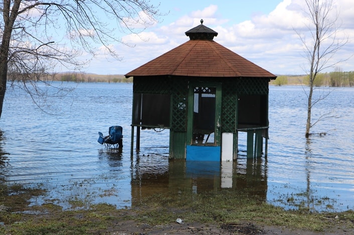A gazebo in a resident’s backyard surrounded by water
