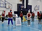Red Cross volunteers in PPE socially distanced in gym.
