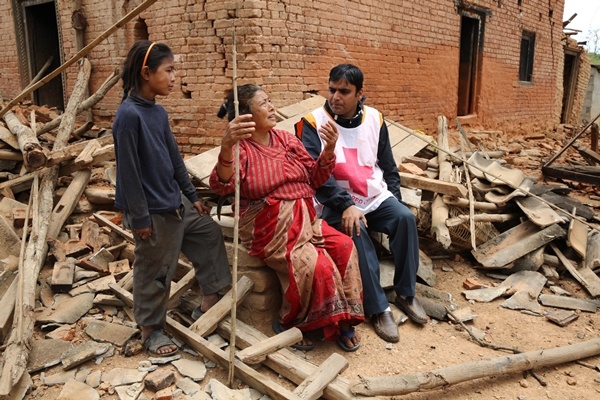 An injured woman is cared for by Nepal Red Cross