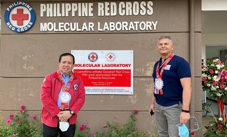 Our Philippines Country Representative Mladen Milicevic at the dedication ceremony for the newly opened molecular lab, standing in front of the building sign