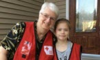 Canadian Red Cross volunteers Hazel and Eryn, smiling outside a home