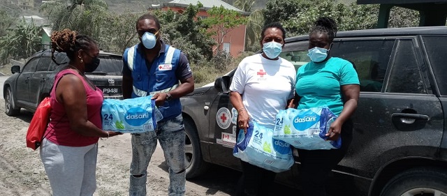 Red Cross volunteers handing out cases of bottled water