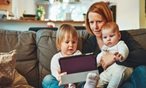 Woman with two children looking at laptop