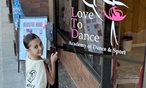 Little girl enters her dance studio