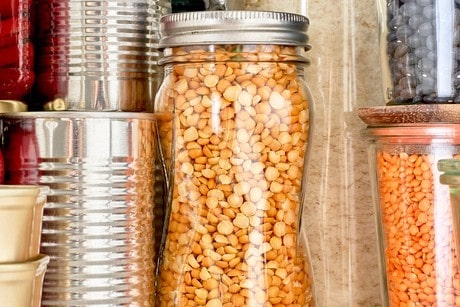 Jars of grains, beans, legumes piled in a pantry