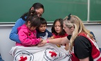 Canadian Red Cross worker allows child to draw on her hand