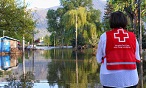 A Canadian Red Cross volunteer looks over a flooded area