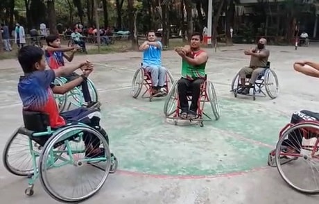 Athletes in wheelchairs circled warming up for a game of basketball