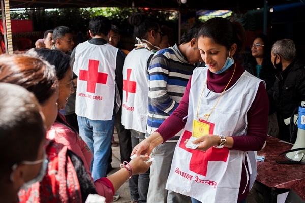Volunteers distribute water purification tablets