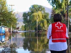 A Canadian Red Cross volunteer looks over a flooded area