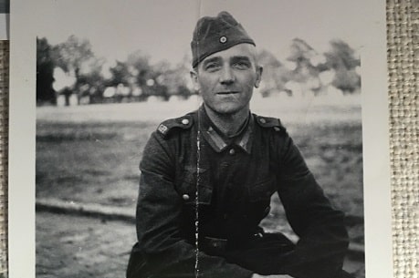 An archived black and white photo of a man in WW2 uniform