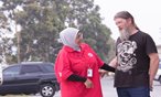 An Australian Red Cross volunteer talks with an evacuee