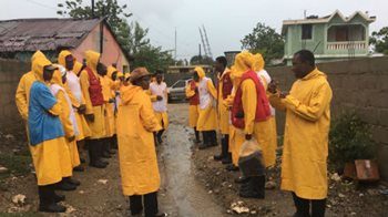 Volunteers dressed in rain gear prepare for Hurricane Irma
