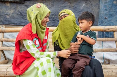 Two women talk at a makeshift settlement in Bangladesh