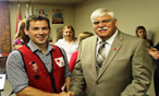 A Canadian Red Cross employee shaking hands with a businessman at a fundraising event