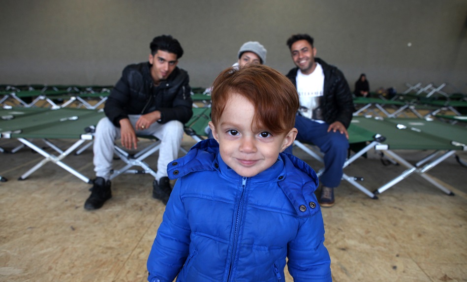 A young boy with his family at the waiting area Feldkirchen, Germany, run by the German Red Cross. 