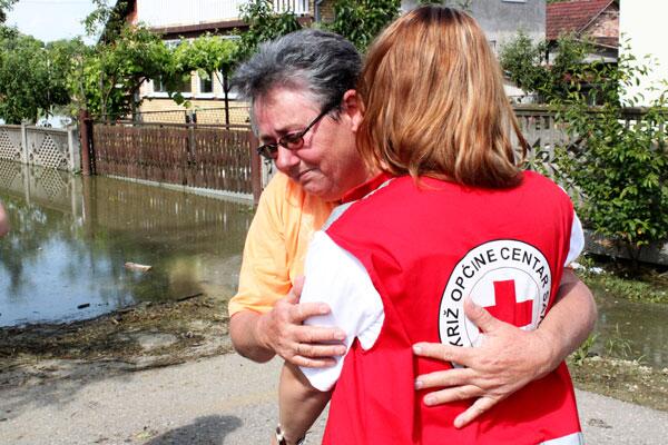 Woman receives hug from Red Cross volunteer