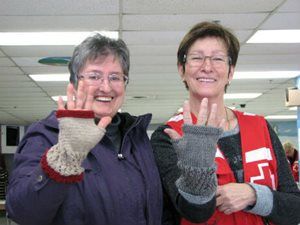 Doris and Red Cross volunteer Michelle with the knitted muffs
