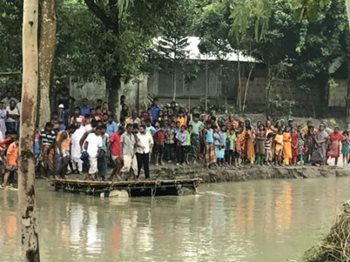 Kagoje Bara villagers crossing by raft after a major section of embankment was washed away during the flood.