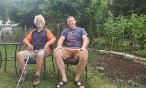Two men sitting in a backyard