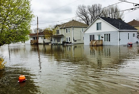 A street lined with houses flooded in high waters