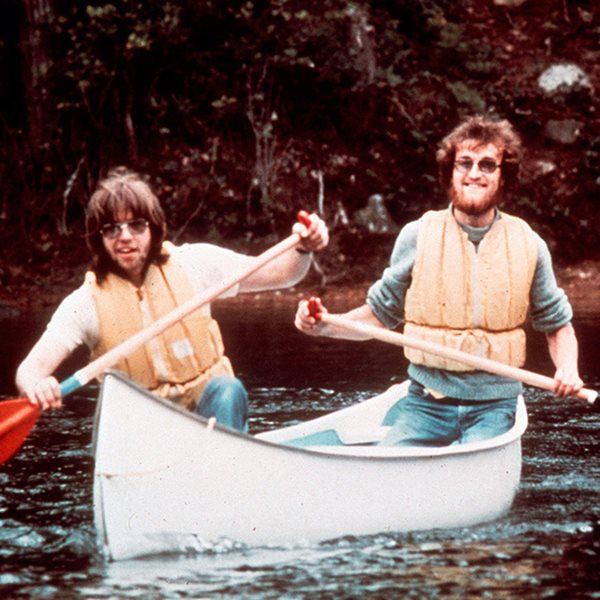 Men canoeing while wearing lifejackets