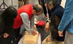 Man practicing CPR on dummy
