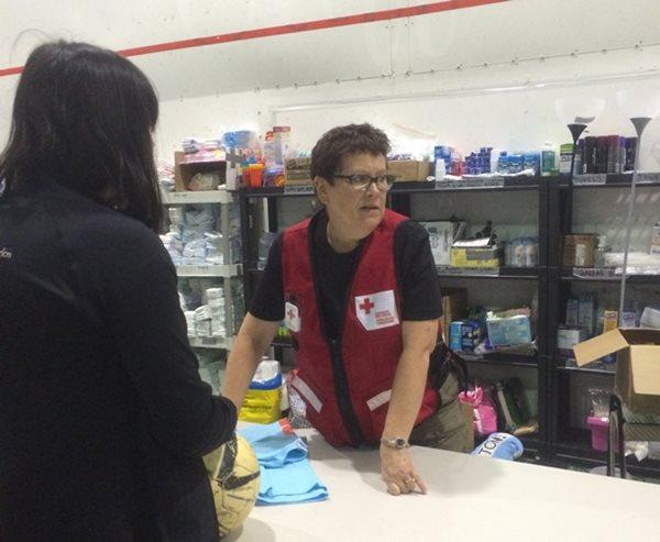 Red Cross volunteer talks to a woman